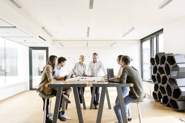 Businesswoman and businessman leading a meeting in office - PESF01939