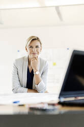 Portrait of confident blond businesswoman in conference room - PESF01966