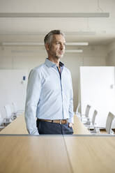 Portrait of mature businessman in conference room thinking - PESF01990