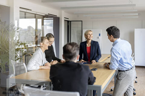 Businesswoman leading a meeting in office stock photo