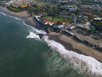 Indonesia, Bali, Dalung, Aerial view of coastal town and Batu Bolong Beach - KNTF04556
