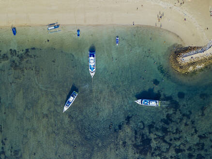 Indonesia, Bali, Sanur, Aerial view of boats moored in front of sandy coastal beach - KNTF04571