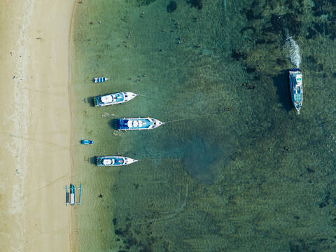 Indonesia, Bali, Sanur, Aerial view of boats moored in front of sandy coastal beach stock photo