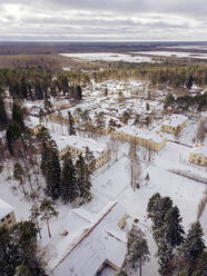 Russia, Leningrad Oblast, Aerial view of snow-covered village - KNTF04587