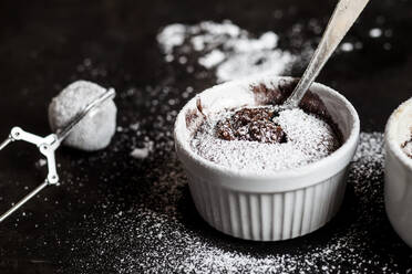 Studio shot of mug of molten chocolate cake with powdered sugar - SBDF04251