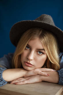 Portrait of blond woman wearing hat looking at camera - AGGF00061
