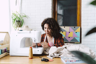 Woman sewing at home - ERRF03539