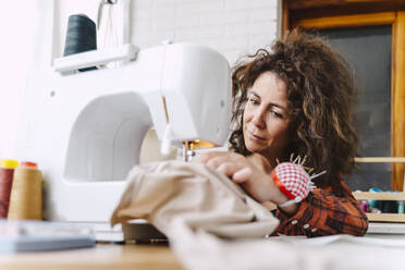 Woman sewing at home - ERRF03563