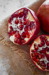 Close-up of halved pomegranate - GIOF08133