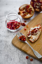 Teaspoon with fresh pomegranate seeds - GIOF08137
