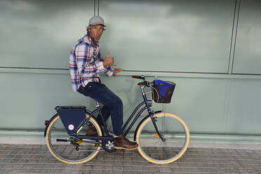 Cyclist with thumb up, El Arenal, Mallorca, Spain - ECPF00889