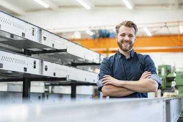 Portrait of a smiling young man in a factory - DIGF10042