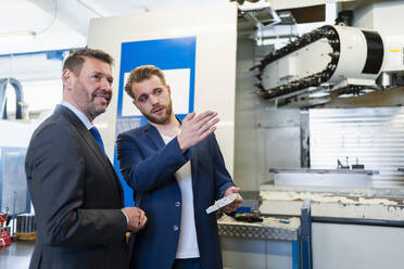 Two businessmen having a work meeting in a factory - DIGF10048