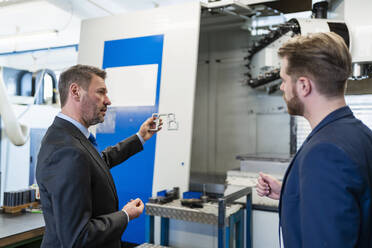 Two businessmen having a work meeting in a factory - DIGF10051