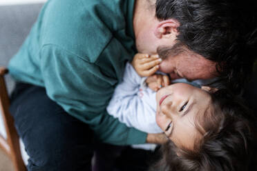 Father playing with his little daughter at home - VABF02849