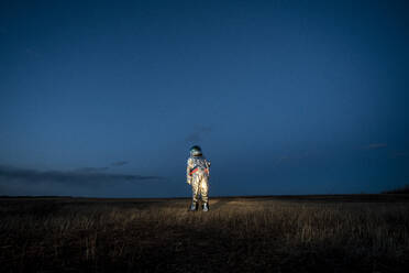 Spacewoman standing on meadow in the evening - VPIF02389