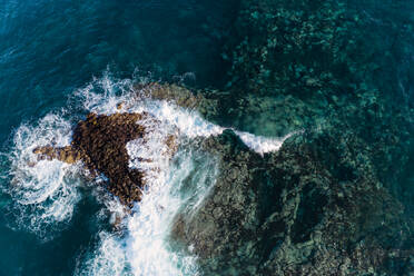 Aerial view of a wave breaking over a sharp lava reef in Tenerife. - CAVF80715