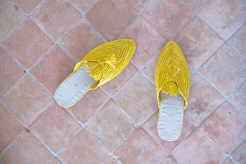 Yellow slippers on a brick floor - CAVF80754