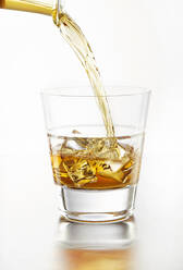 Liquor on the Rocks Pouring into Tumbler - CAVF80803