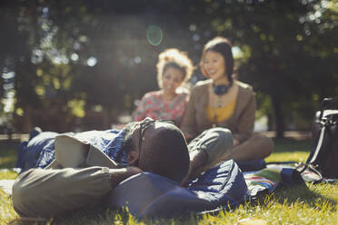 Young friends relaxing in sunny summer park - CAIF26293