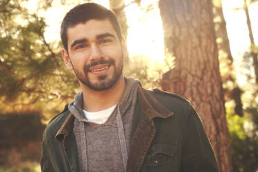 Portrait confident young man in woods - CAIF26307