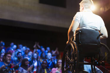 Das Publikum klatscht für eine Rednerin im Rollstuhl auf der Bühne - CAIF26318