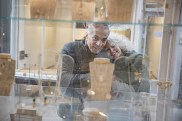 Senior couple window shopping at jewelry storefront - CAIF26421