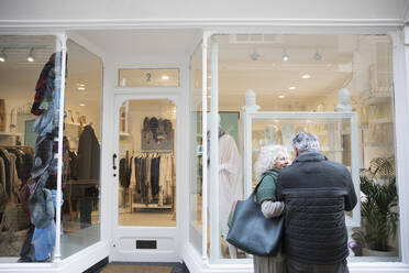 Senior couple window shopping at storefront - CAIF26433