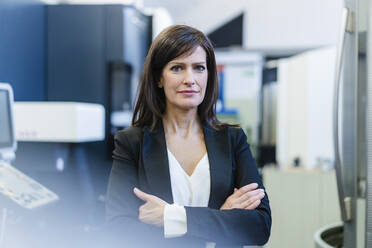 Portrait of a confident businesswoman in a factory - DIGF10109