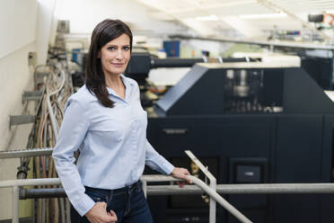 Portrait of a confident businesswoman in a factory - DIGF10236