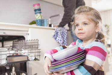 Daughter clearing the dishwasher, father in the background - SDAHF00772