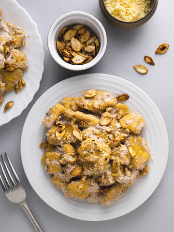 Plate of homemade gnocchi with pumpkin seeds stock photo