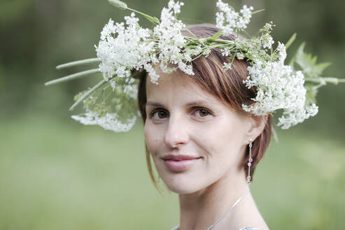 Close-up portrait of woman wearing white flowers - EYAF01057