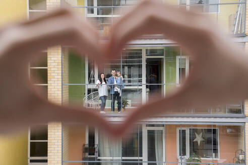 Woman's hands shaping heart with hands for her neighbours - AHSF02450