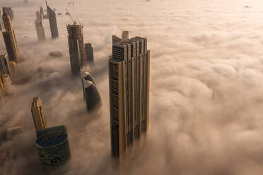 Aerial view of buildings surrounded by clouds Dubai, United Arab Emirates - AAEF07981