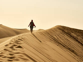 Woman on the ridge of a dune in the desert, Walvis Bay, Namibia - VEGF02079