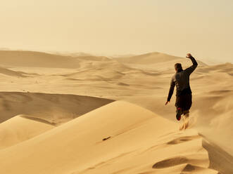 Man running on a dune in the desert, Dune 7, Walvis Bay, Namibia - VEGF02084