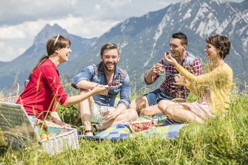Friends having a picnic on a meadow in the mountains, Achenkirch, Austria - SDAHF00814