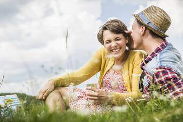 Happy couple having a picnic on a meadow in the mountains, Achenkirch, Austria - SDAHF00823
