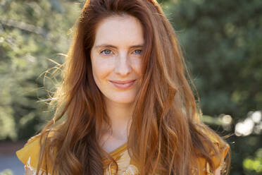 Portrait of smiling redheaded woman outdoors - AFVF06190
