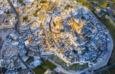 Zenithal aerial view of the old town of Ostuni at sunset, Apulia, Italy, Europe - RHPLF14816
