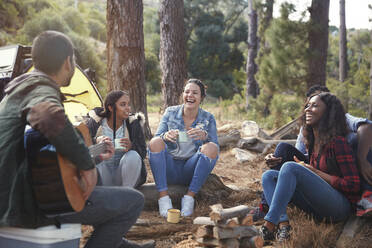 Young friends laughing, hanging out at campsite - CAIF27189