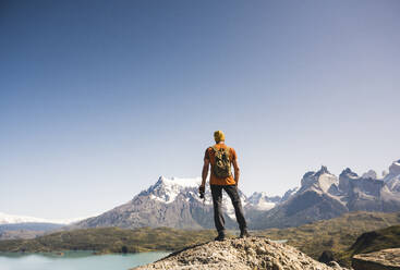 Hiker in mountainscape at Lago Pehoe in Torres del Paine National Park, Patagonia, Chile - UUF20237