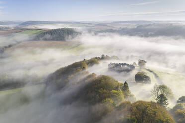 Luftaufnahme einer Drohne vom Herbstnebel, der über Restormel Castle in Cornwall, Vereinigtes Königreich, Europa, wirbelt - RHPLF14904