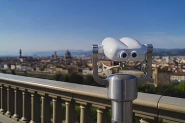 Italy, Tuscany, Florence, Close-up of coin-operated binoculars overlooking city - FMOF00974