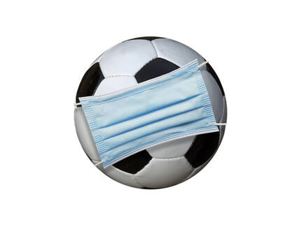 Football covered by surgical mask on white background - BSCF00618
