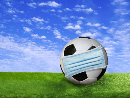 3D rendering, Soccer ball covered by surgigal mask on soccer field - BSCF00621