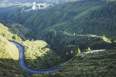 High angle view of winding mountain road near green forest, San Miguel, Azores, Portugal - FVSF00247