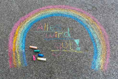 Painted rainbow on street with text 'Everything will fall into place' - SARF04558