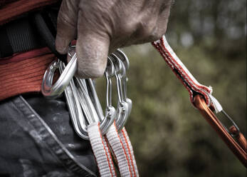 Unclipping a rock climbing karabiner - ALRF01747